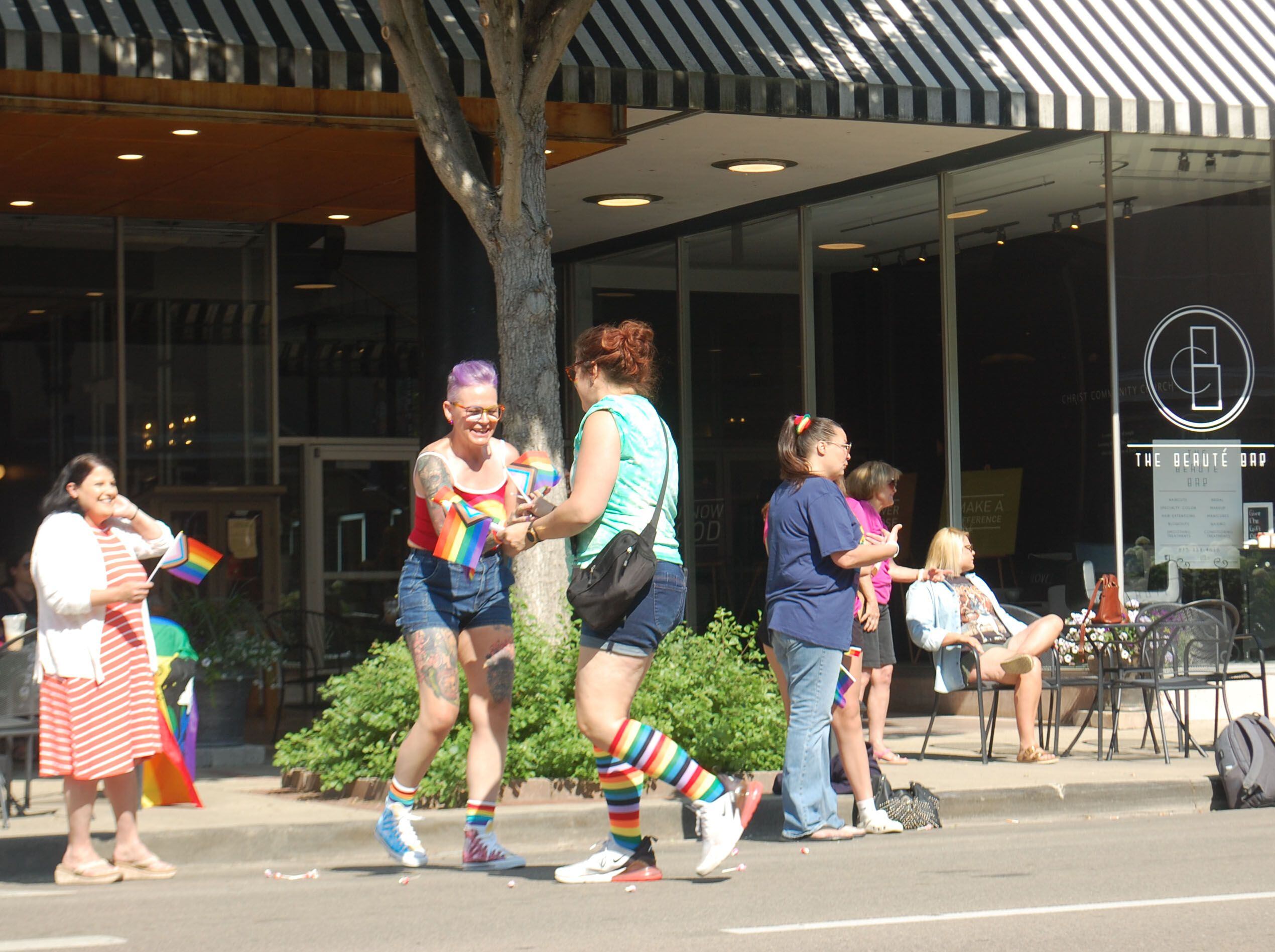 A paradegoer receives Pride flags during the John Fisher Dann Memorial Pride Parade in downtown Ottawa on Saturday, June 10, 2023.