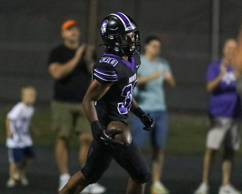 Downers Grove North's James Lumpkin (30) runs in the endzone for a touchdown during a football game between Glenbard West at Downers Grove North on Friday, Sept 13th, 2024  in Downers Grove.