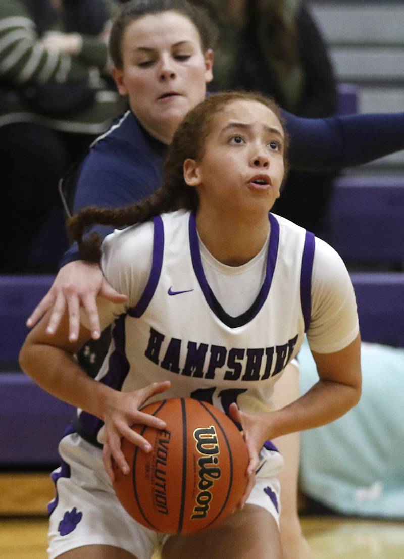 Hampshire's Mikala Amegasse drives to the basket as Cary-Grove's Emily Larry tries to knock the ball away during a Fox Valley Conference girls basketball game Friday, Jan. 26, 2024, at Hampshire High School.