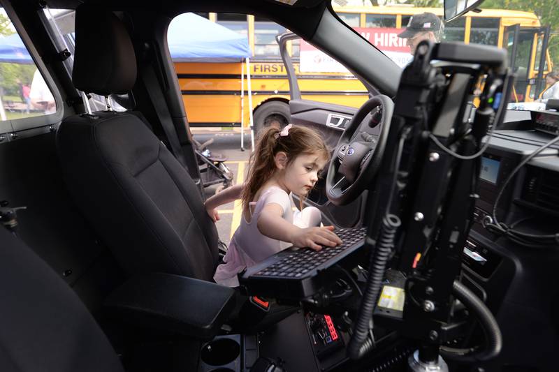 Carly Morroni of Lagrange Park plays with the computer keyboard inside a police car while attending the Touch A Truck event held at Sedgwick Park Saturday May 11, 2024.