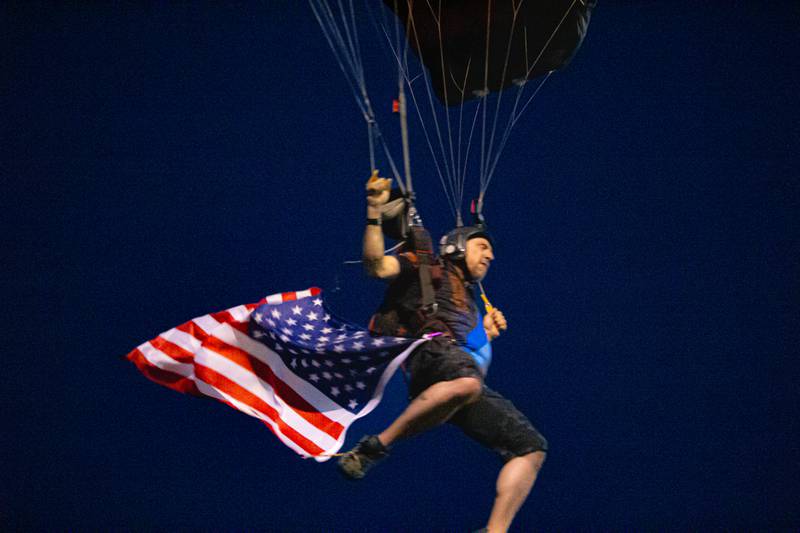 Skydiver of Skydive Chicago Flys in with American Flag on Thursday, July 4, 2024 at Ottawa High School.