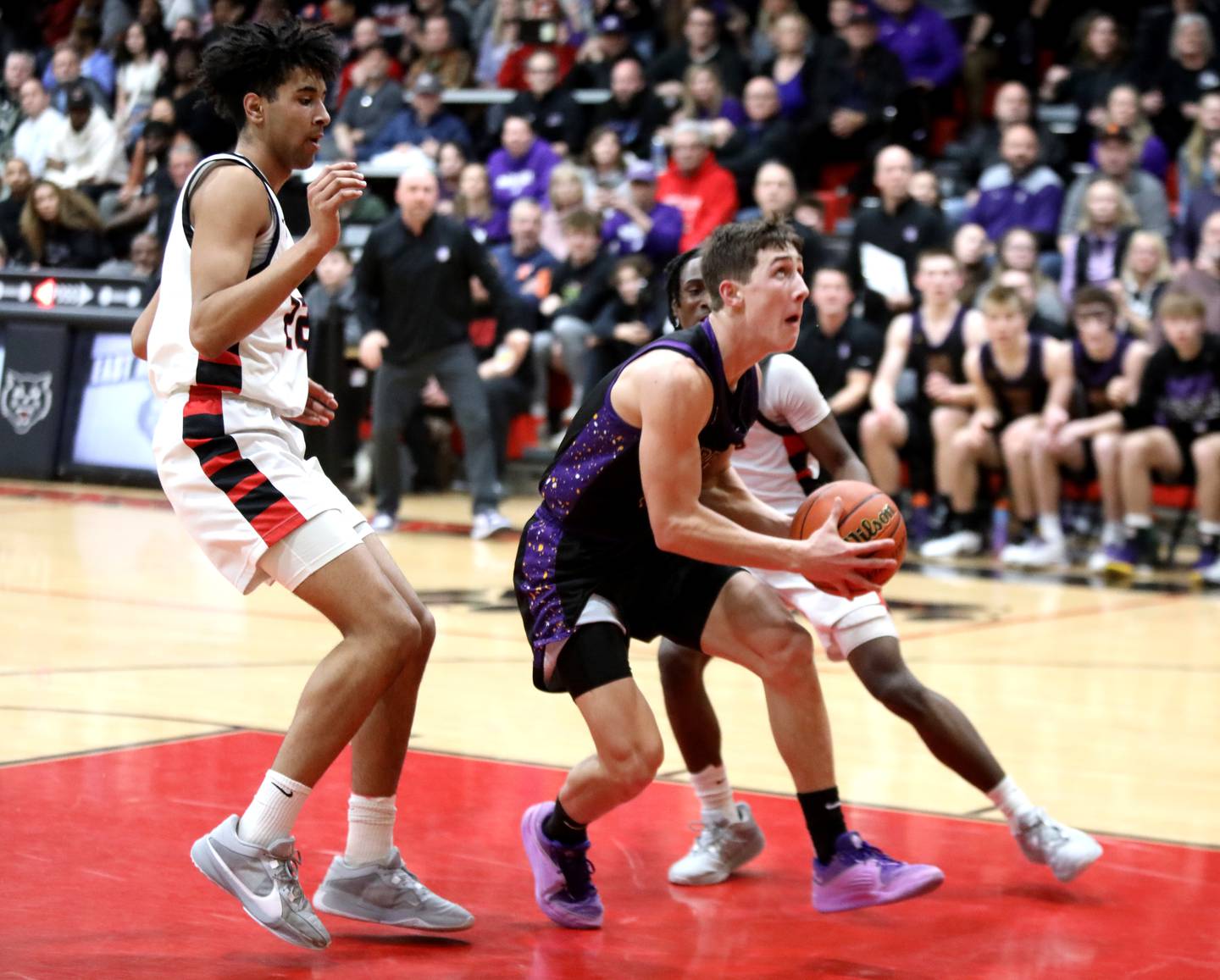 Downers Grove North’s Jack Stanton looks for an opening from under the basket during the Class 4A East Aurora Boys Basketball Sectional final against Bolingbrook on Friday, March 1, 2024.