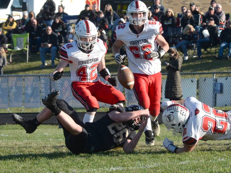 Forreston's Bryce Miller (42), Alex Schoonhaven (62) and Kaleb Sanders (22) react to a loose ball during second round action of the 1A playoffs at Lena-Winslow on Saturday, Nov. 4, 2023. The Cardinals fell to the Panthers 46-14.