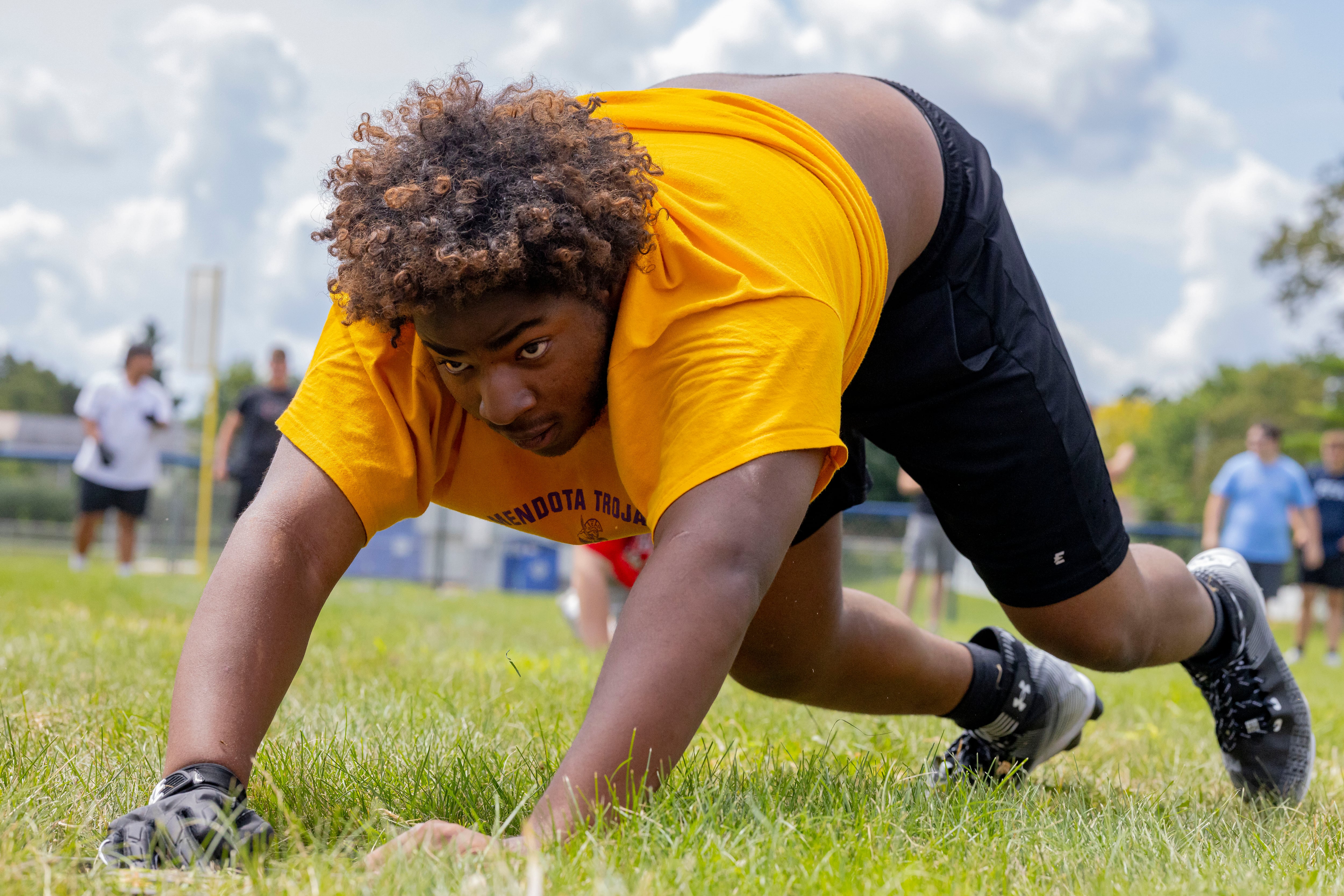 Michael Thornhill of Mendota High School participates in the weight plate push relay during a multiple high school practice football meet at Princeton High School on July 20, 2024.