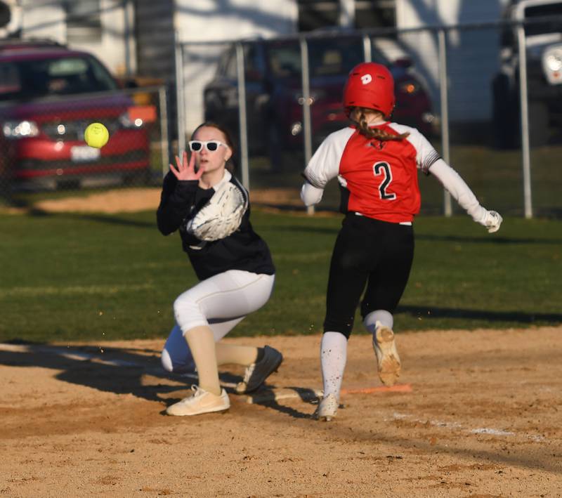 Polo's first baseman waits for throw as Forreston's Alaina Miller makes it to the base safely during an April 6 game with Forreston.