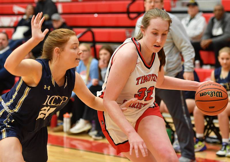 Timothy Christian's Grace Roland (right) drives past IC Catholic's Maura Grogan during the Class 2A Timothy Christian Regional championship game on Feb. 17, 2023 at Timothy Christian High School in Elmhurst.