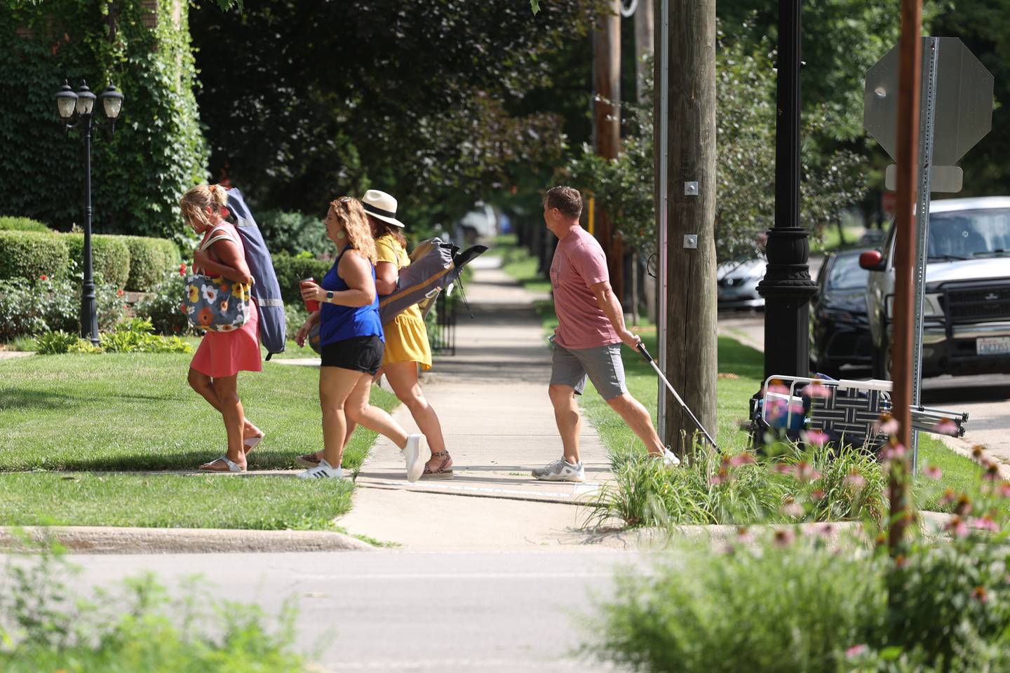 A group of people hand from one musical act to another along Western Avenue. The Upper Bluff Historic District hosted Parch & Park Music Fest featuring a variety of musical artist at five different locations. Saturday, July 30, 2022 in Joliet.