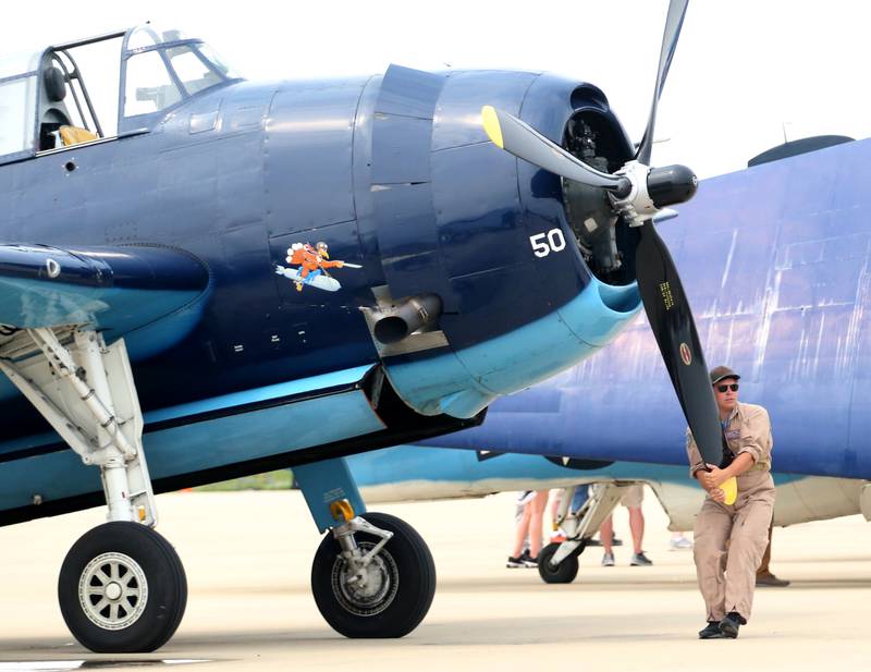 A pilot turns the propeller of a TBM Avenger during the TBM Avenger Reunion on Friday, May 19, 2023 at the Illinois Valley Regional Airport in Peru.