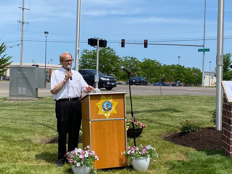 DeKalb veteran and special events organizer Michael Embrey gives remarks at the new first responders memorial outside Isaac Executive Suites, 2675 Sycamore Road, DeKalb, during a dedication ceremony held Sunday, May 19, 2024. The memorial was unveiled at the close of National Police Week.
