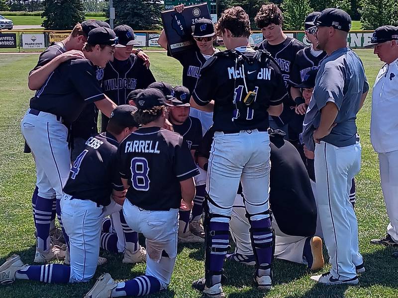 The Wilmington baseball team congregates with its new hardware after its win over Peoria Notre Dame in the Geneseo Class 3A Super-Sectional on Monday.