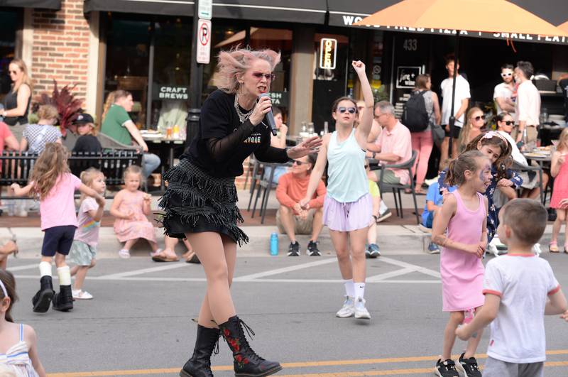 Altered Suburbia lead singer and teacher at Lincoln Elementary School, Amy Bishop entertains families during the concert held downtown Glen Ellyn Friday June 8, 2024.