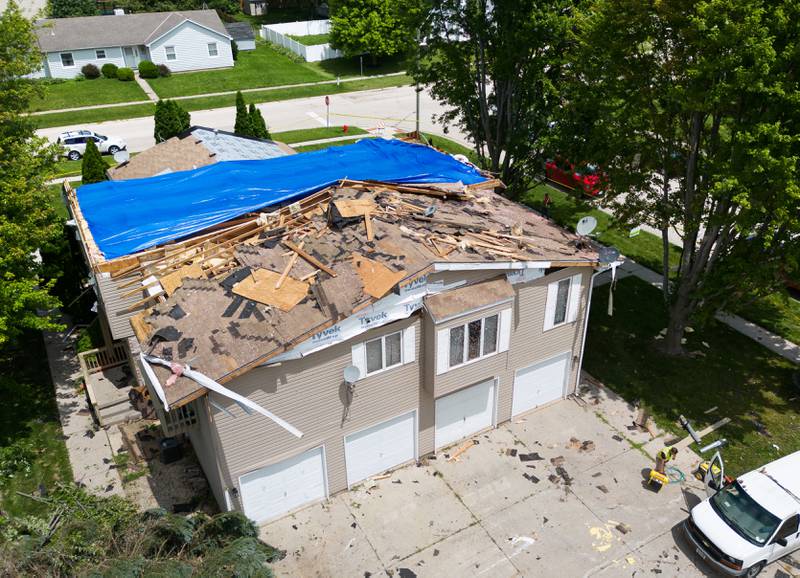 Construction crews work Thursday at a four-unit apartment building at Douglas Avenue and Timer Drive W in Huntley after receiving heavy roof damage from Wednesday, July 12, 2023, storms.