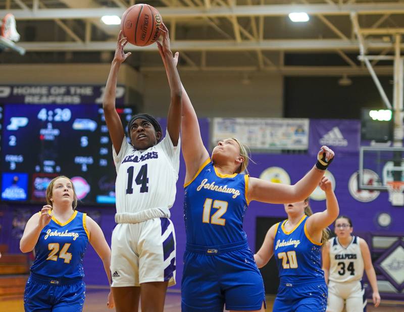 Plano's Luniah Gilford (14) rebound the ball against Johnsburg's Kaylee Fouke (12) during a basketball game at Plano High School on Tuesday, Jan 30, 2024.