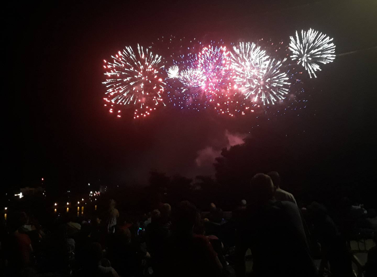 Fireworks explode over the Illinois River in Ottawa as spectators watch Monday, July 4, 2022, from the South Side along Prospect Avenue.