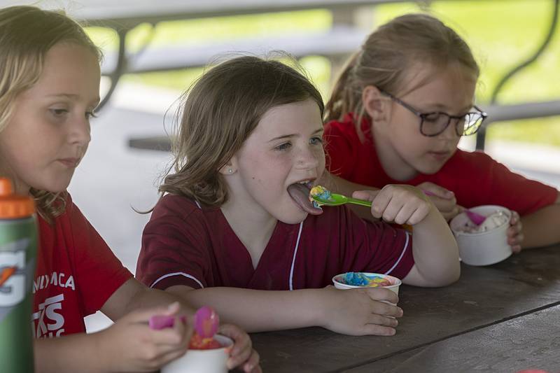 Maggie Shaddock, a first-grader at St. Anne’s School, digs into her Superman ice cream Wednesday, May 29, 2024, during an afternoon of fun at the school.