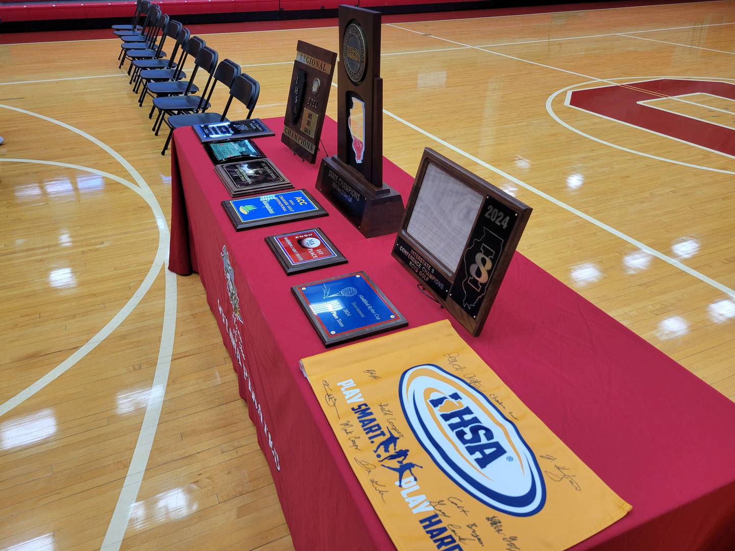 The 2024 Ottawa boys golf team's tournament championship hardware, including the IHSA Class 2A championship trophy, were on display during Sunday's ceremony honoring the team in Kingman Gym.