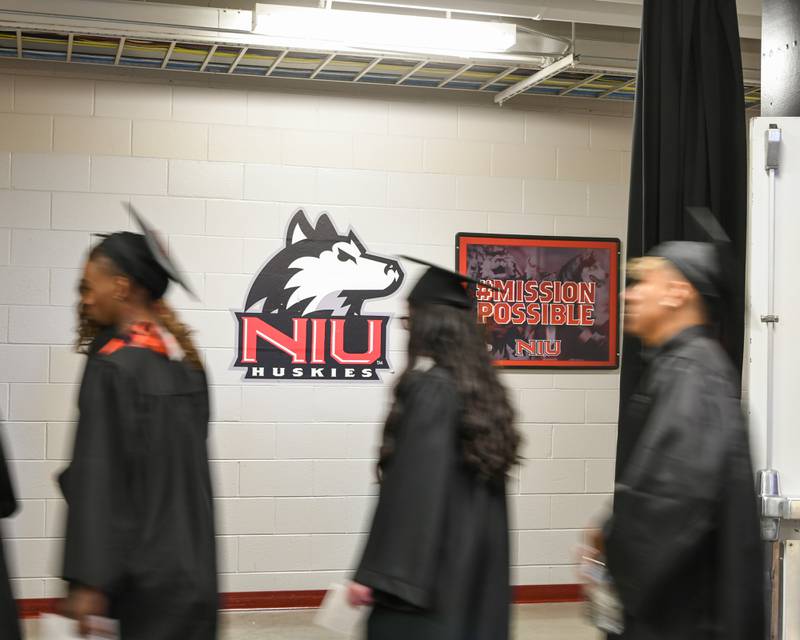 DeKalb High School Class of 2024 graduates walk from Victor E. Court Gym to the arena of the Northern Illinois University Convocation Center before the start of the commencement ceremony held on Saturday, May 25, 2024.