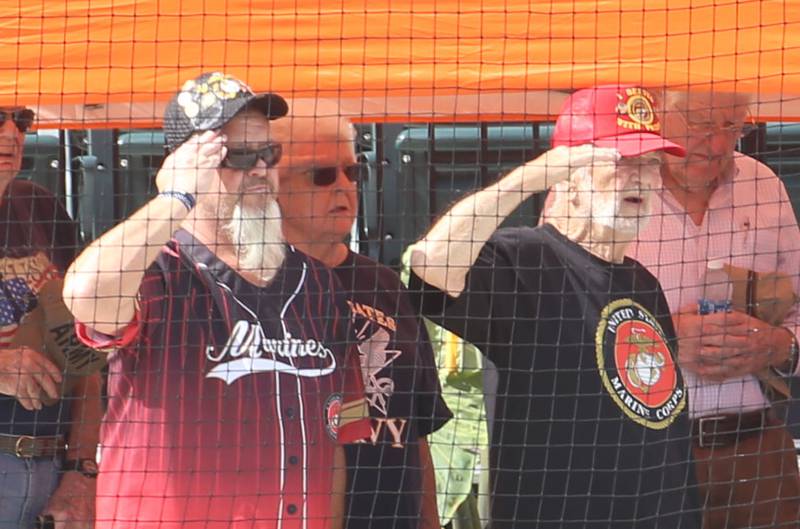 Veterans salute during the National Anthem on Wednesday, July 3, 2024 in Schweickert Stadium at Veterans Park in Peru. The Pistol Shrimp held their annual Salute to Veterans honoring local members who served in the military.