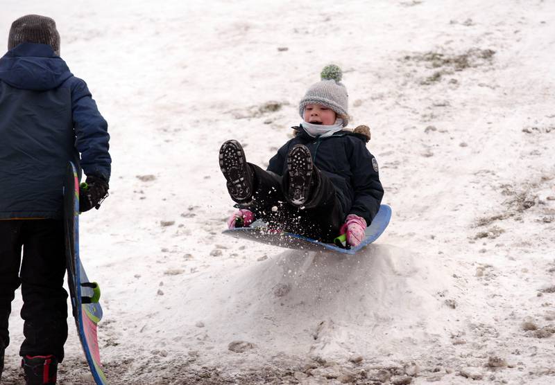 Children including Maura McMahon of LaGrange enjoy the winter storm sledding at Memorial Park in Lagrange Park Saturday, Jan 13, 2024.