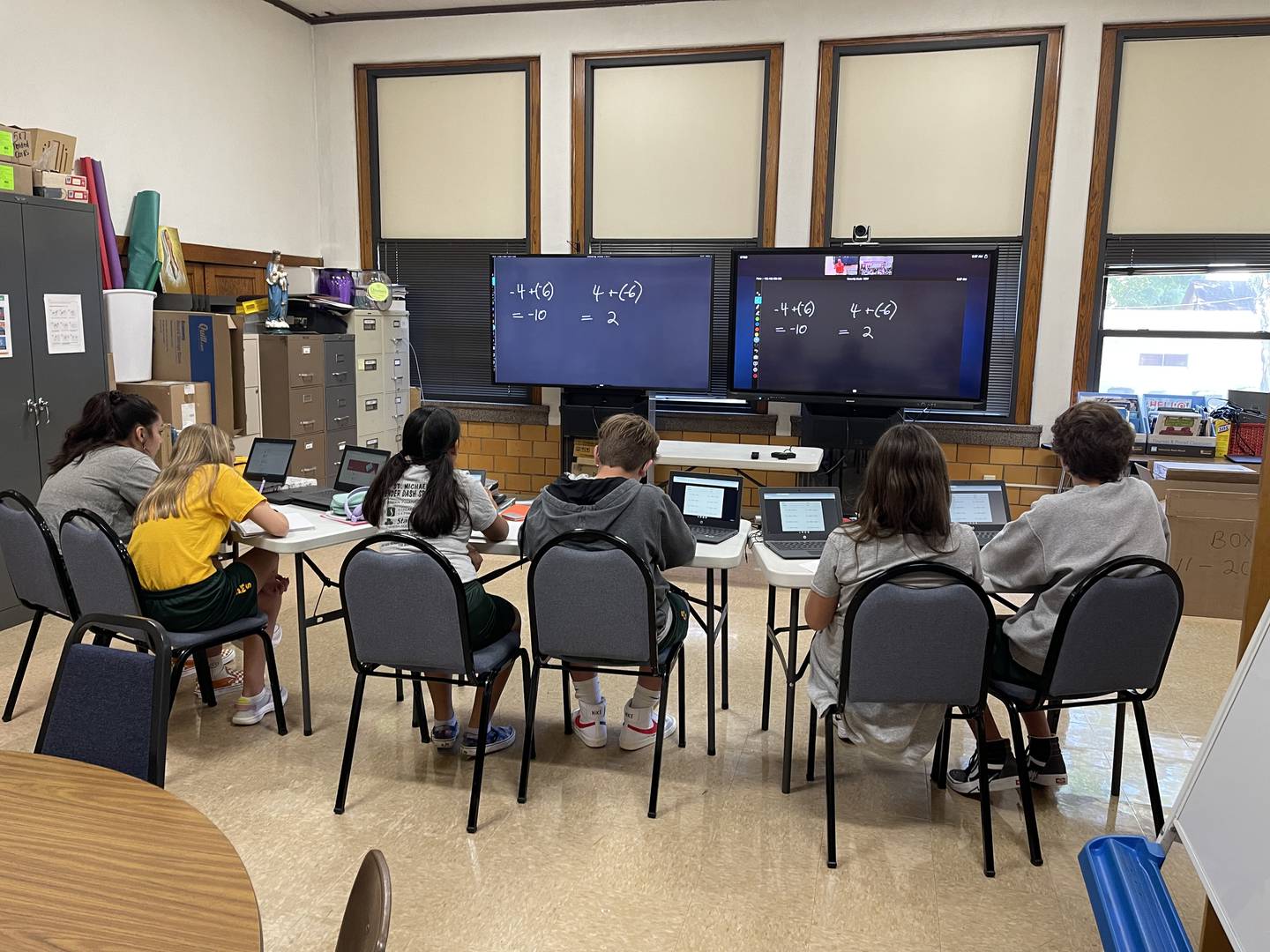 St. Michael the Archangel Catholic School eighth graders watch the algebra lessons from a Streator High School classroom go onto TV screens as they participate in the blended classroom.