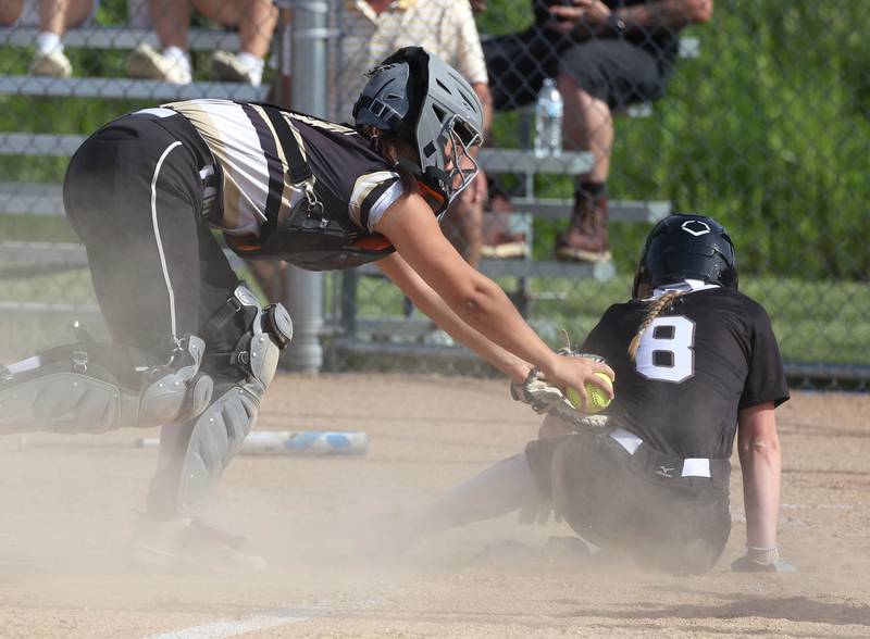 Prairie Ridge's Adysen Kiddy scores a run just ahead of the tag of Sycamore's Kairi Lantz during their Class 3A sectional final Friday, May 31, 2024, at Sycamore High School.