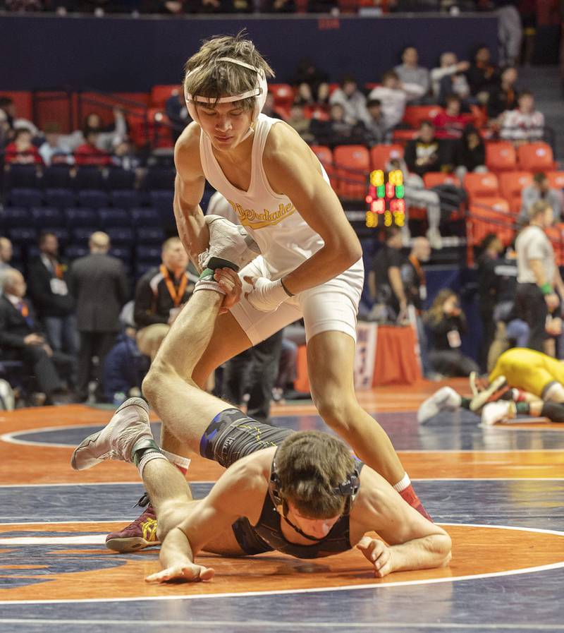 Riverdale’s Dean Wainwright grasps onto the leg of Oblong’s Ian Rosborough in the 120 pound 1A third place match Saturday, Feb. 17, 2024 at the IHSA state wrestling finals at the State Farm Center in Champaign.