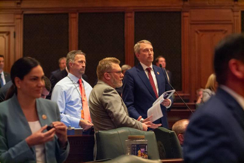 Rep. Patrick Windhorst, R-Metropolis, reads the House rules as members of his party look on. His procedural maneuvering forced Democratic leadership to suspend the rules in order to get enough members in the chamber to pass the revenue plan.