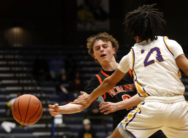 McHenry's Tyler Hurckes passes the ball as he is pressured by Hononegah's Darian Tholin during the IHSA Class 4A Guilford Boys Basketball Sectional semifinal game on Wednesday, Feb. 28, 2024, at Rock Valley College in Rockford.