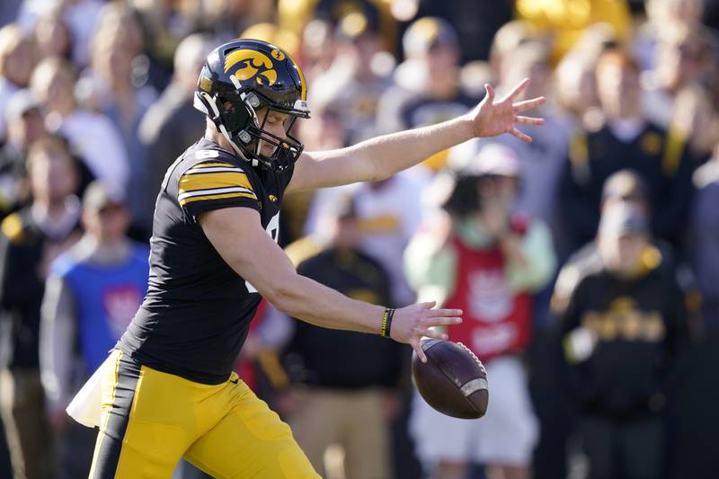 Iowa punter Tory Taylor (9) punts during the first half of a 2021 NCAA college football game against Purdue in Iowa City, Iowa.