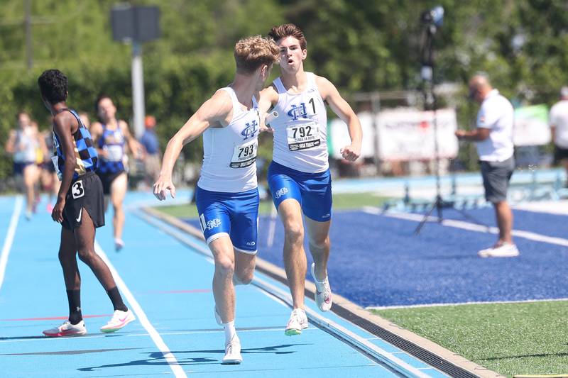 Sterling Newman’s Lucas Schaab hands the baton off to Lucas Simpson in the Class 1A 4x800 relay at the IHSA State Meet held Saturday, May 25, 2024, in Charleston.
