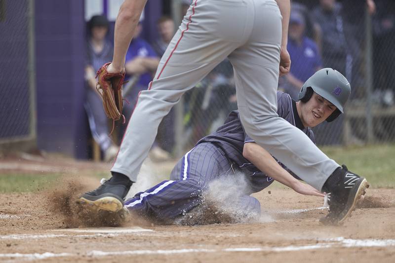 Dixon’s Bryce Feit steals home against Rockford Jefferson Wednesday, March 13, 2024 to open the Dukes’ baseball season.