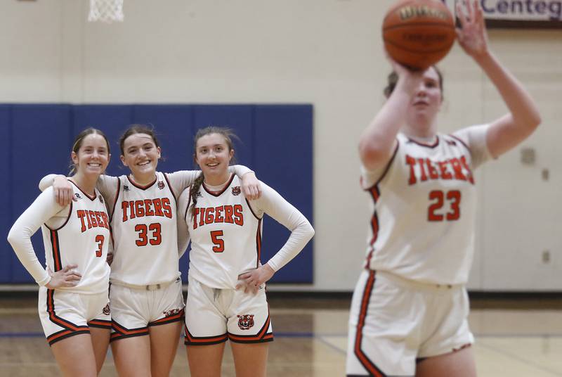 Crystal Lake Central's Ella Madalinski, Katie Hamill and Addison Cleary watch as their teammate, Leah Spychala, shoots a free-throw in the last minute of  the IHSA Class 3A Woodstock Regional Championship girls basketball game against Burlington Central on Thursday, Feb. 15, 2024, at Woodstock High School.