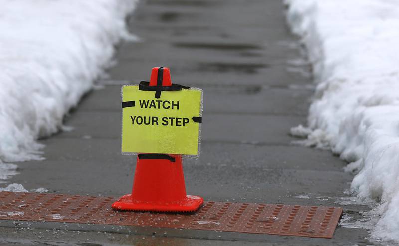 A caution sign at Veteran Acres Park in Crystal Lake on Tuesday, Jan. 23, 2023. Residents throughout northern Illinois woke up to icy and slippery roads.