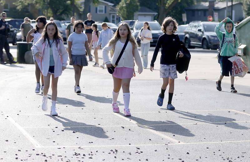 Children walk through the playground for the first day of school on Wednesday, Aug. 21, 2024, at Coventry Elementary School in Crystal Lake.