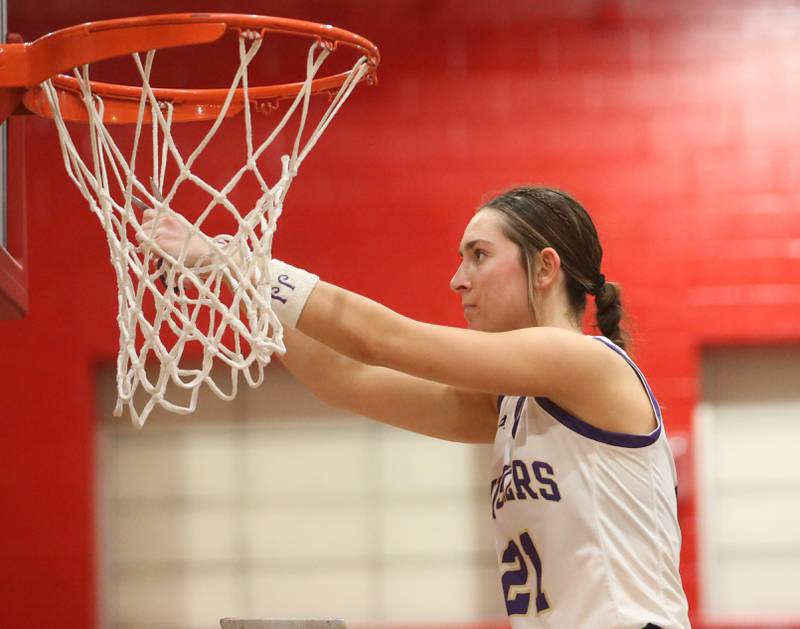 Serena's Makayla McNally cuts a piece of the net down after defeating Ashton-Franklin Center in the Class 1A Regional on Thursday, Feb. 15, 2024 at Earlville High School.