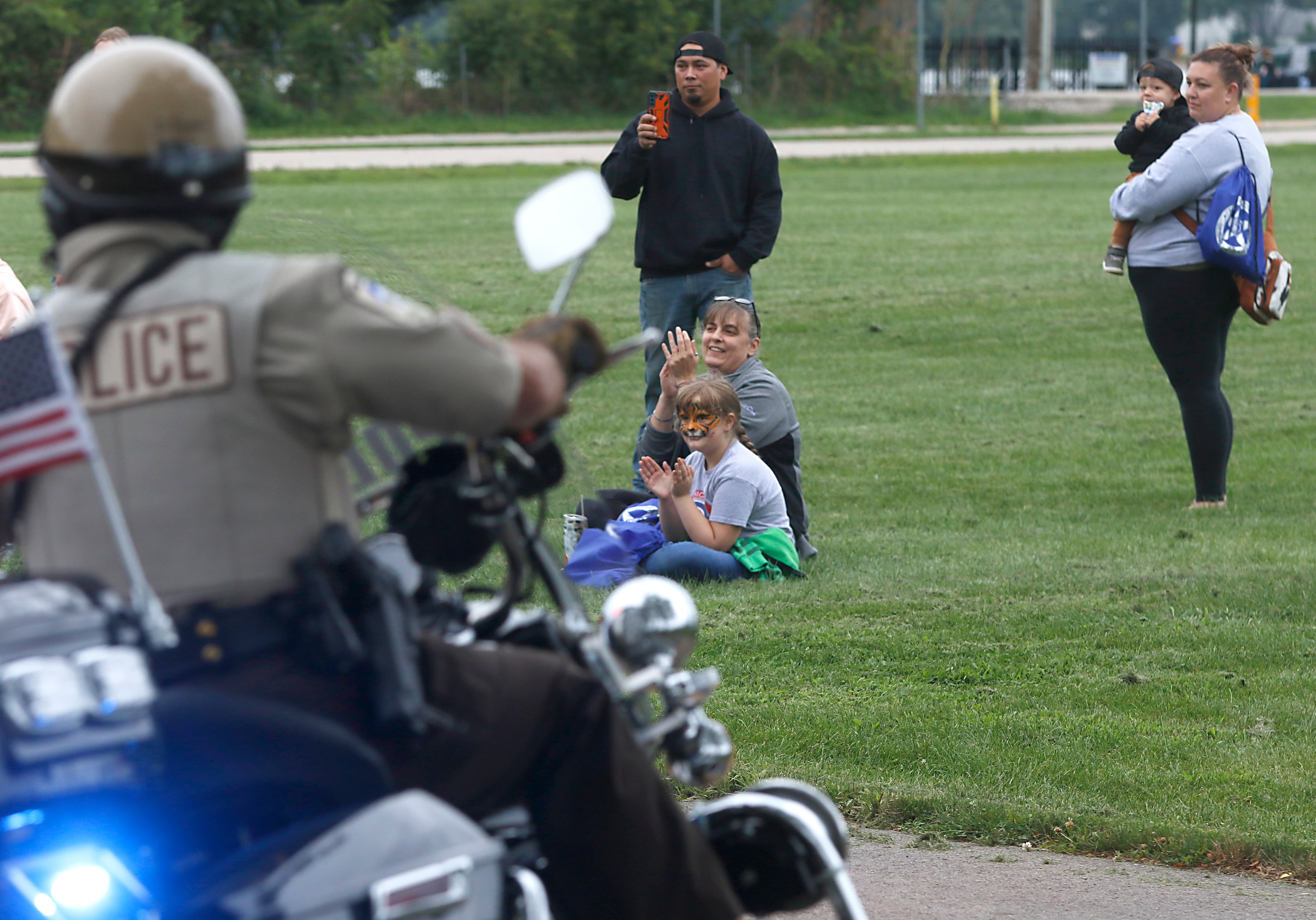 People watch the motorcycle demonstration during a National Night Out event Tuesday, Aug. 6, 2024, at Petersen Park in McHenry.