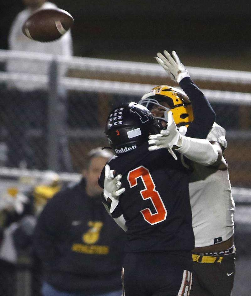 Jacobs' Prince Barnes tries to catch the football as he is hit by McHenry's Rogelio Rios during a Fox Valley Conference football game on Friday, Oct. 18, 2024, at McKracken Field in McHenry.