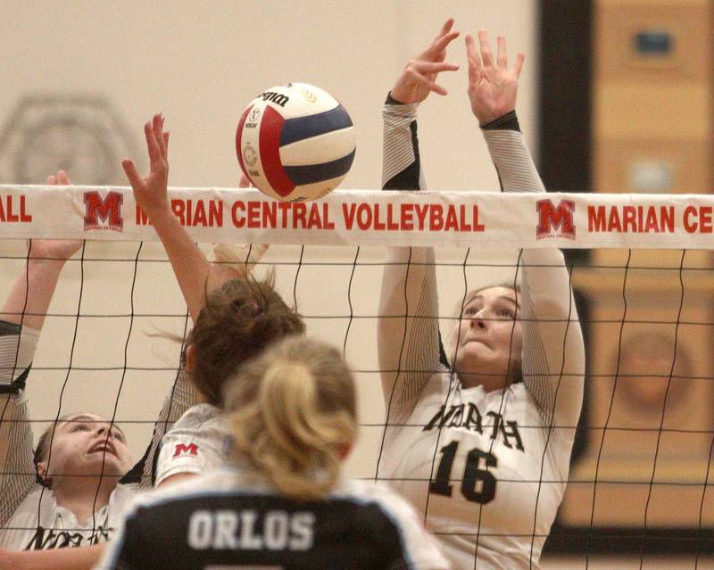 Grayslake North’s Hailey Ryan (16) blocks against Marian Central in girls volleyball in Woodstock Monday.