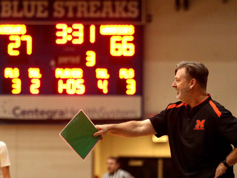 McHenry’s Head Coach Corky Card guides the Warriors against Kaneland in Hoops for Healing basketball tournament championship game action at Woodstock Wednesday.