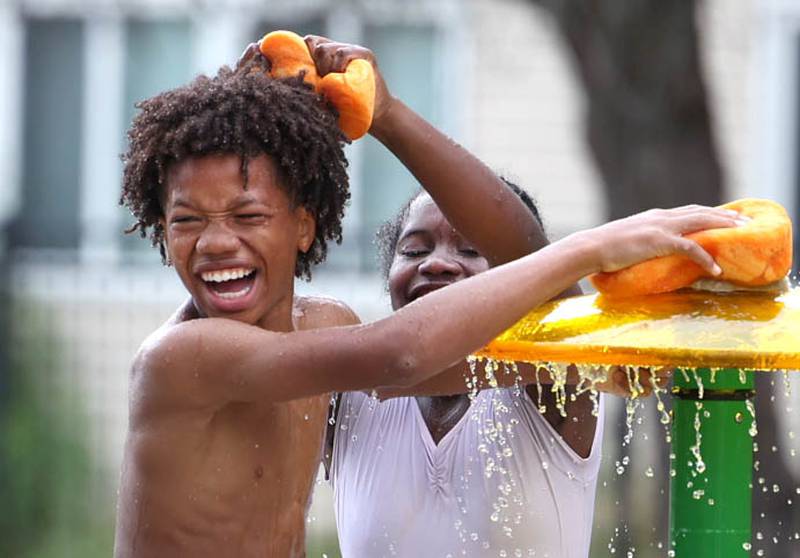 Kids play on the splash pad Thursday, June 20, 2024, at the DeKalb Park District’s Welsh Park. High temperatures have been over 90 degrees every day this week making splash pads and pools very popular destinations.