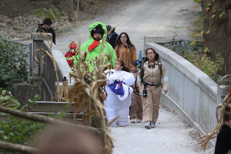 A family returns from the hayride at the Hayride of Horrors on Monday, Oct. 14, 2024 at Dellwood Park in Lockport.