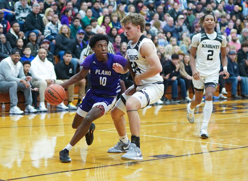 Plano's Davione Stamps (10) drives the baseline against Kaneland’s Parker Violett (34) during a championship game of the 60th annual Plano Christmas Classic Basketball Tournament at Plano High School on Saturday, Dec 30, 2023.