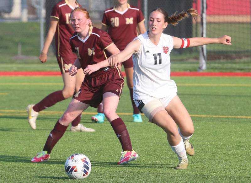 L-P's Danica Scoma and Morris's Makensi Martin run to the ball during the Class 2A Regional semifinal game on Wednesday, May 15, 2024 at the L-P Athletic Complex in La Salle.