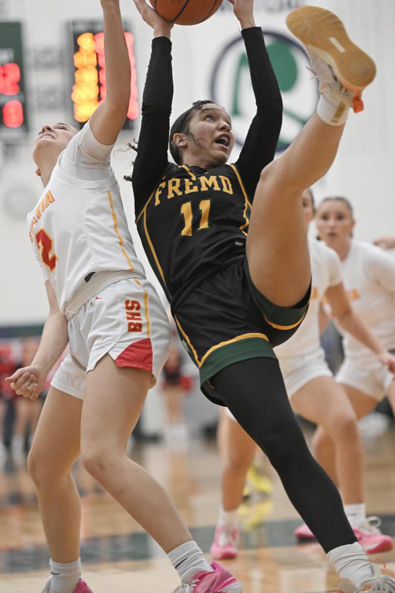 Fremd’s Coco Urlacher falls as she grabs a rebound against Batavia’s Brooke Carlson in the Bartlett supersectional game on Monday, Feb. 26, 2024.