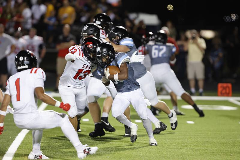 Willowbrook's Jovon Boyd (30) is wrapped up by Glenbar East's Cameron Ducato (13) during the varsity football game between Glenbard East and Willowbrook high schools on Friday, Sep. 30, 2024 in Villa Park.