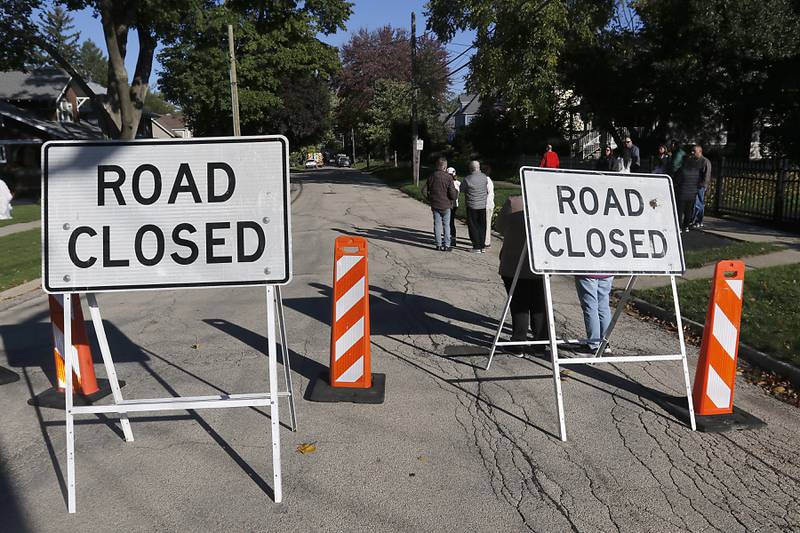 Lincoln Avenue is closed a firefighters battle a house fire in the 300 block of Lincoln Avenue in Woodstock Monday, Oct. 9, 2023, after an explosion following suspected gas leak in the area.