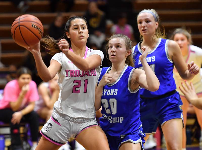 Downers Grove North's Campbell Thulin passes the ball as Lyons Township's Avery Mezan (20) and Kennedy Wanless during a game on Jan. 30, 2024 at Downers Grove North High School in Downers Grove .