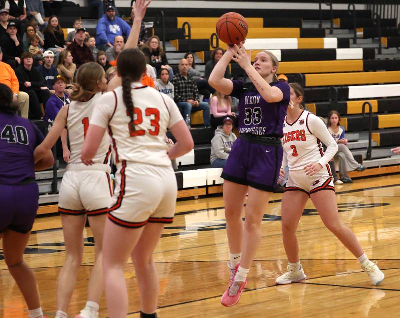 Dixon’s Jessie Pitman shoots over a pair of Crystal Lake Central defenders during their Class 3A sectional semifinal Tuesday, Feb. 20, 2024, at Sycamore High School.