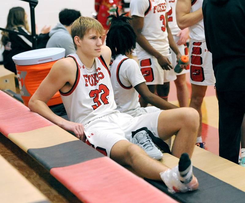 Yorkville's Jason Jakstys ices his left foot during a varsity basketball game against Plano at Yorkville High School on Tuesday, Dec. 19, 2023.