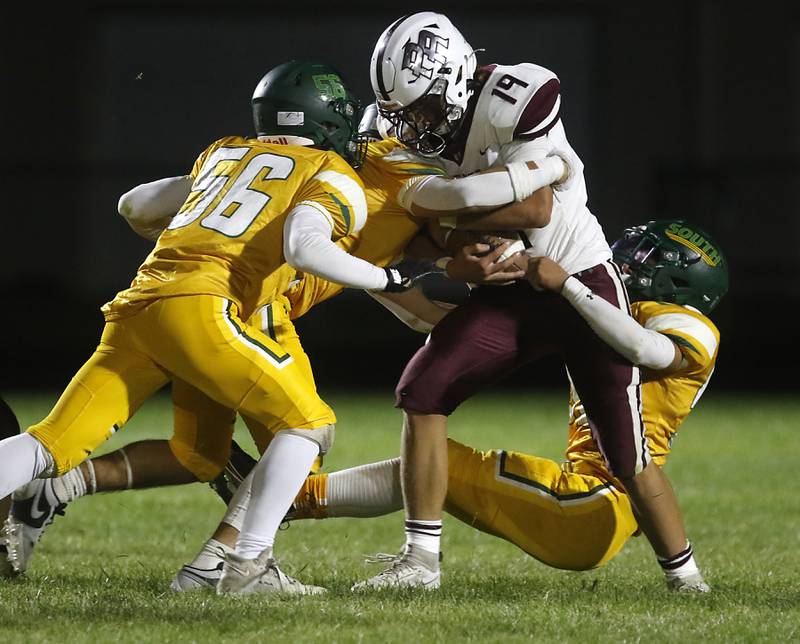 Prairie Ridge's Jake Wagler fights to stay up as he is tackled by a host of Crystal Lake South players during a Fox Valley Conference football game on Friday, Sept. 6, 2024, at Crystal Lake South High School.